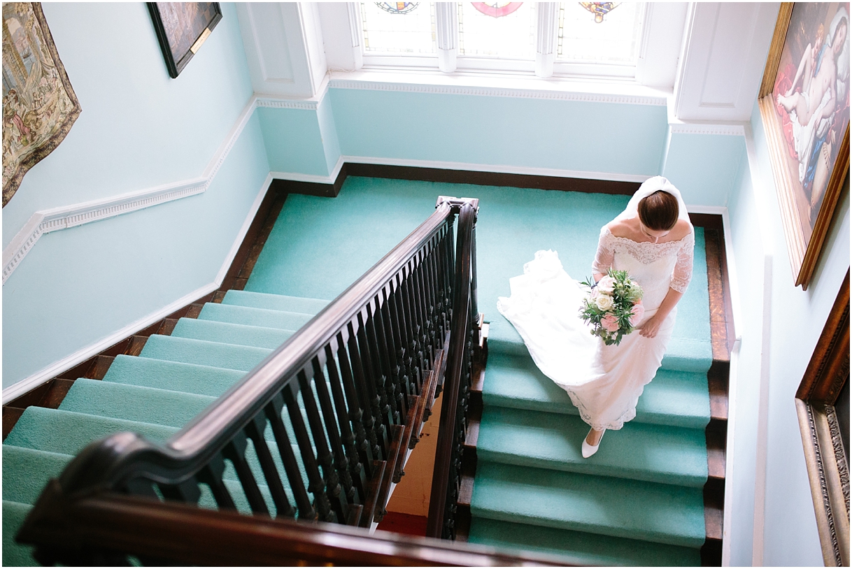 Bride walking down the stairs at Chiddingstone Castle