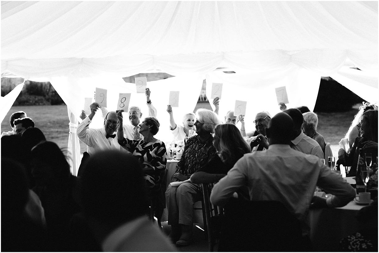 Guests holding up score cards during speeches