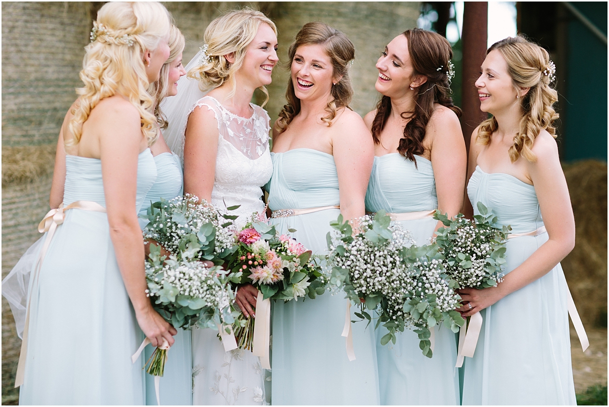 Bride with bridesmaids laughing
