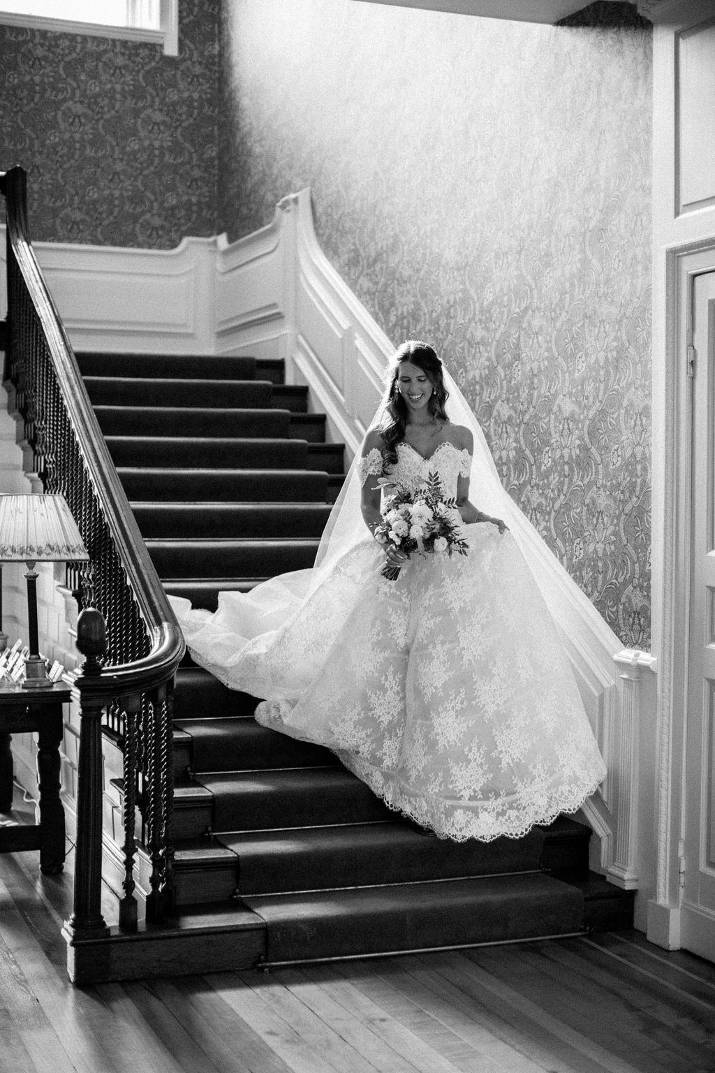 Bride walking down stairs at Ardington House