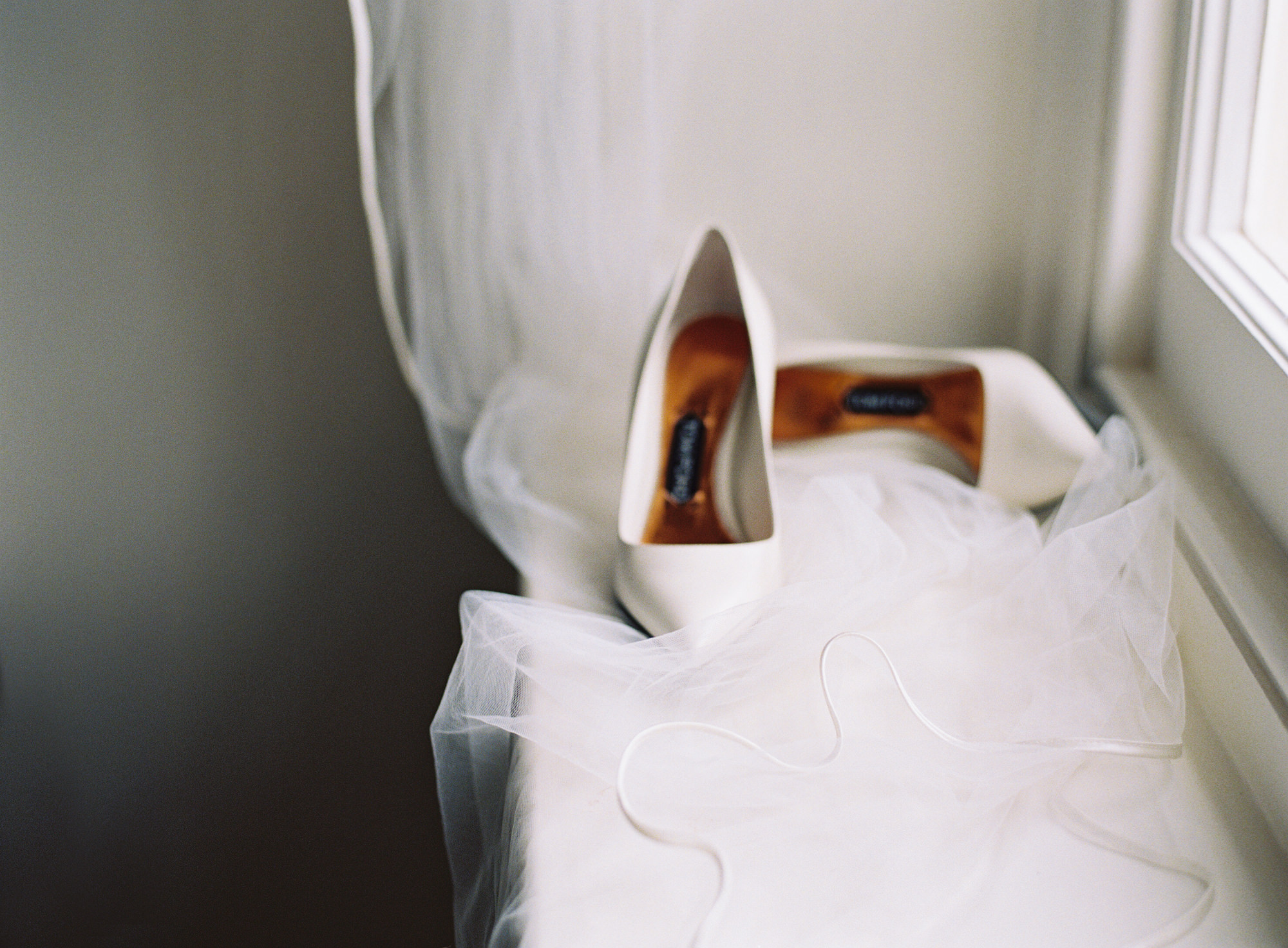 Tom Ford wedding shoes with veil on windowsill at Thorpe Manor Oxford