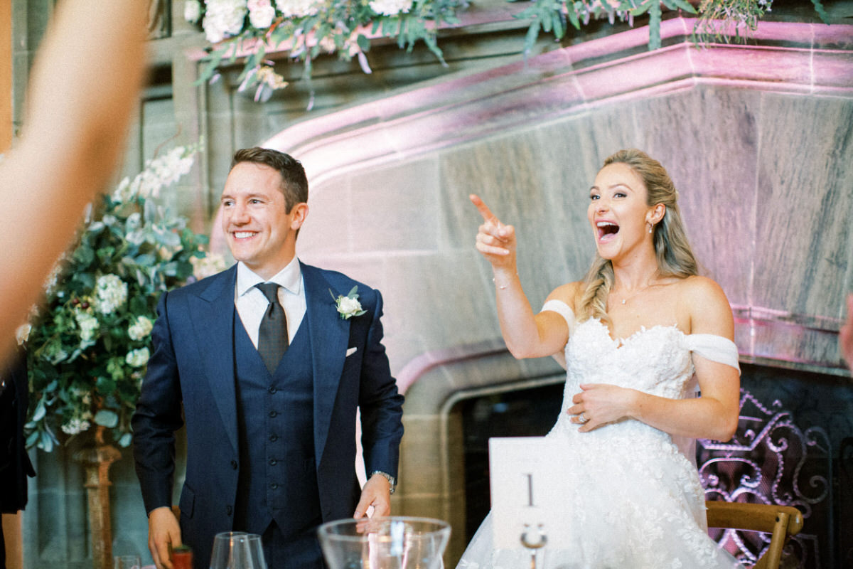 bride and groom laughing during speeches