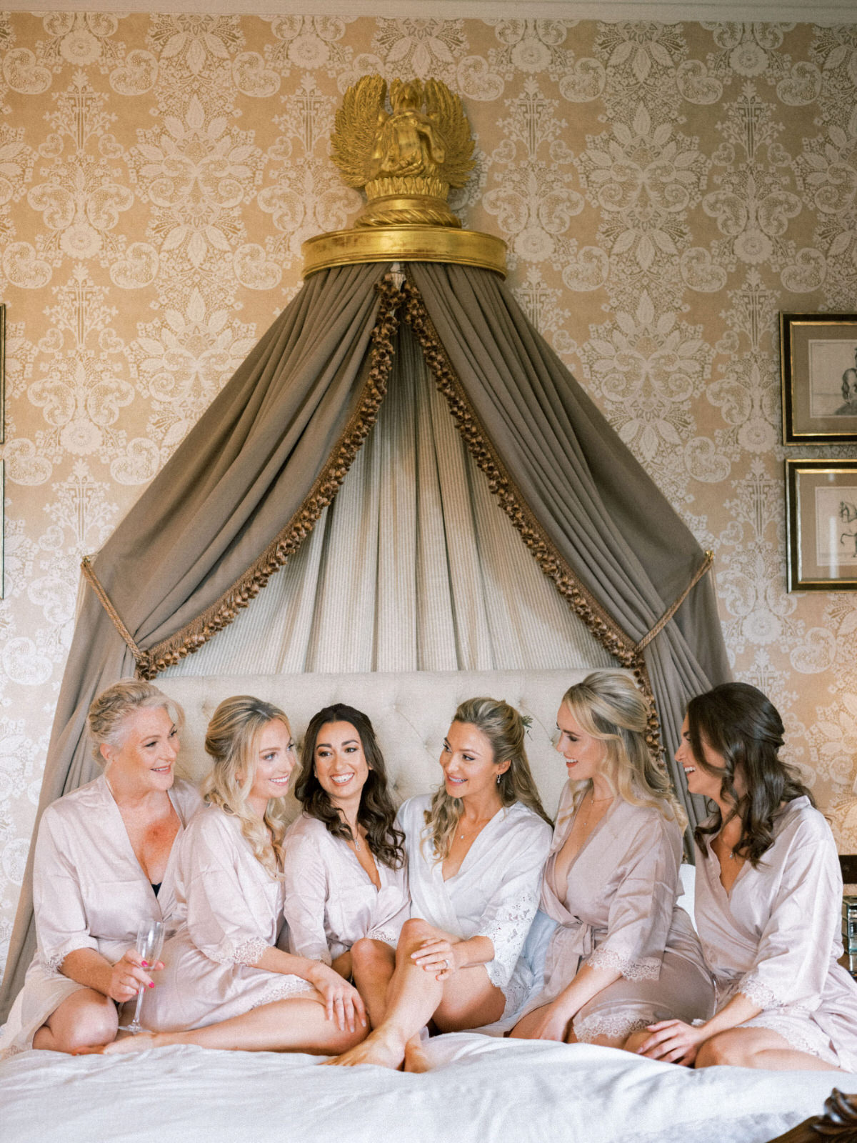 bride and bridesmaids laughingstocks on bed