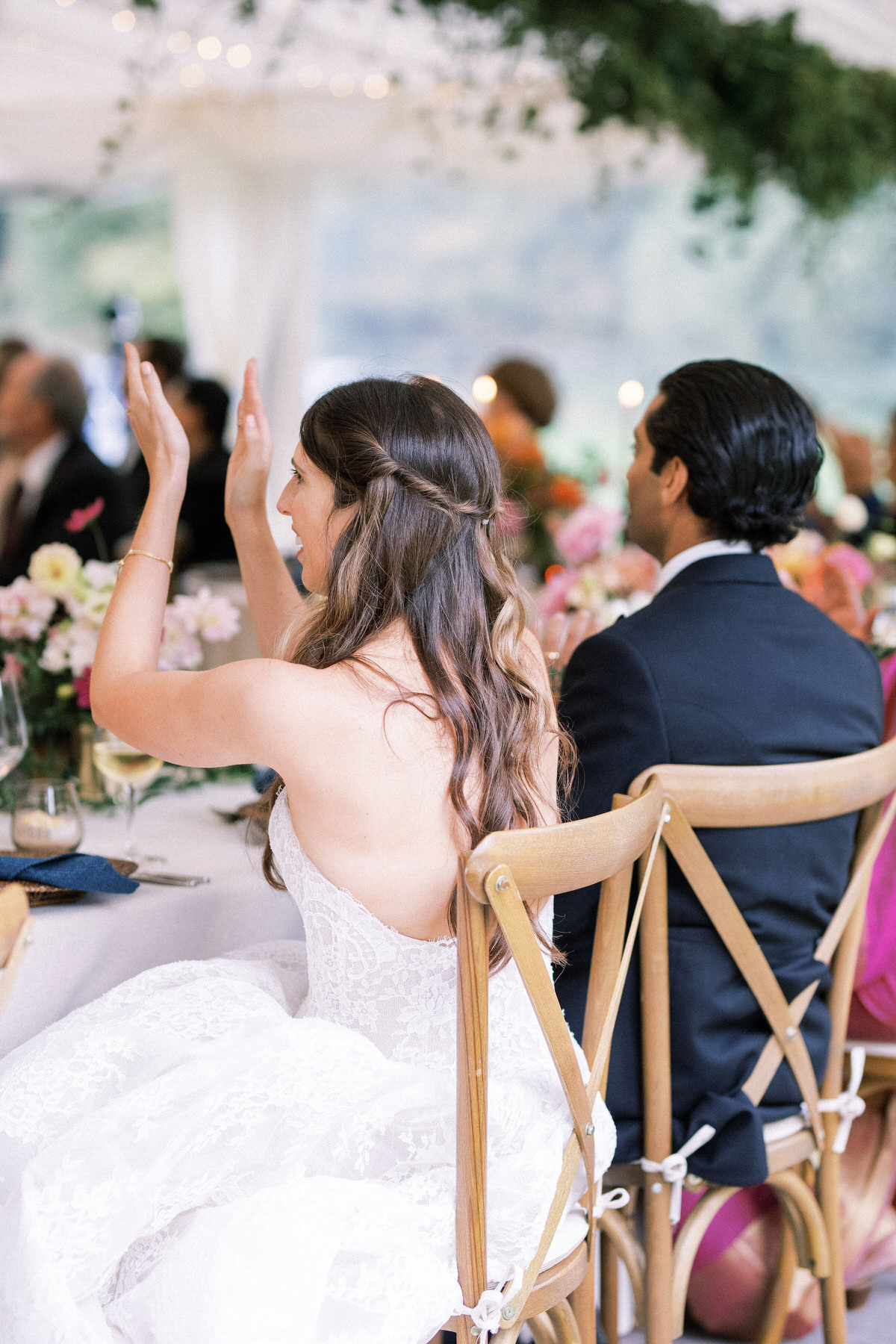 bride and groom clapping during speeches