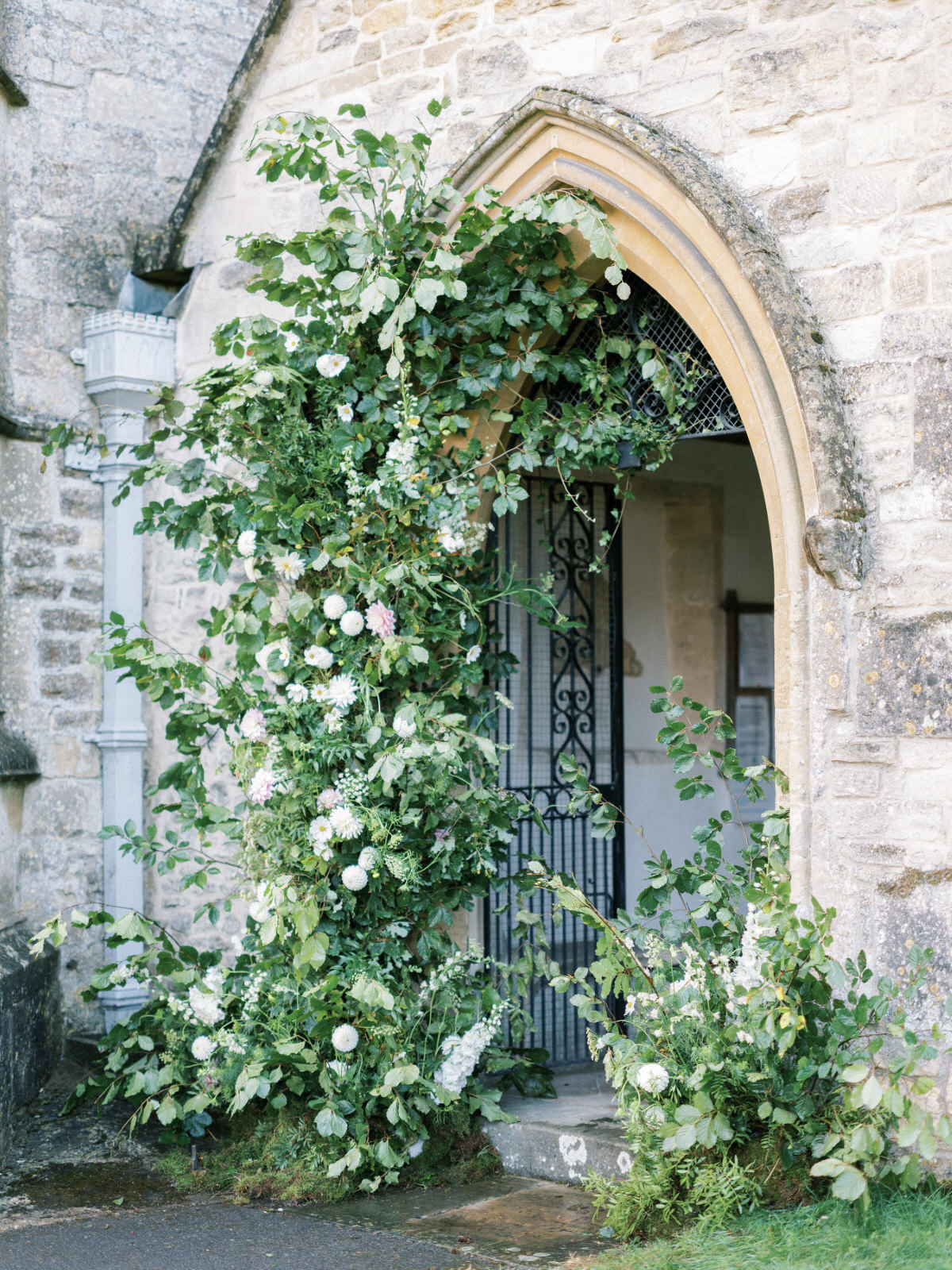 green and white large church wedding arch