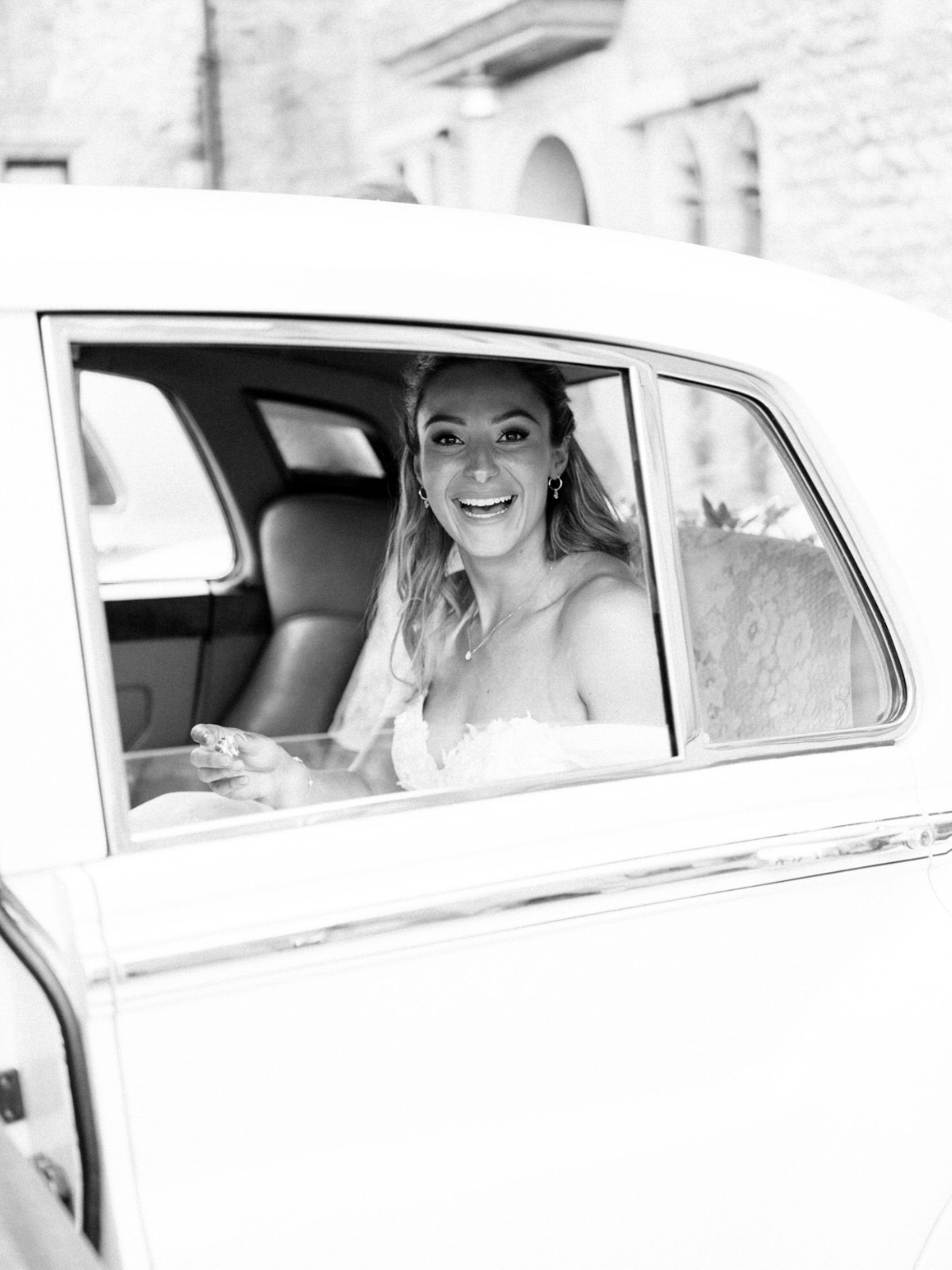 bride smiling in Bentley wedding car
