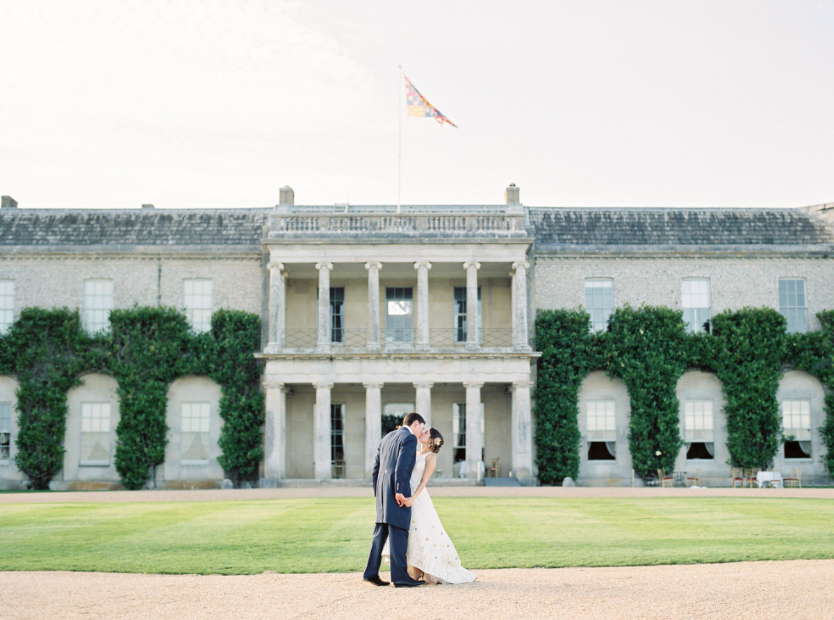 Bride and groom kissing at Goodwood House wedding