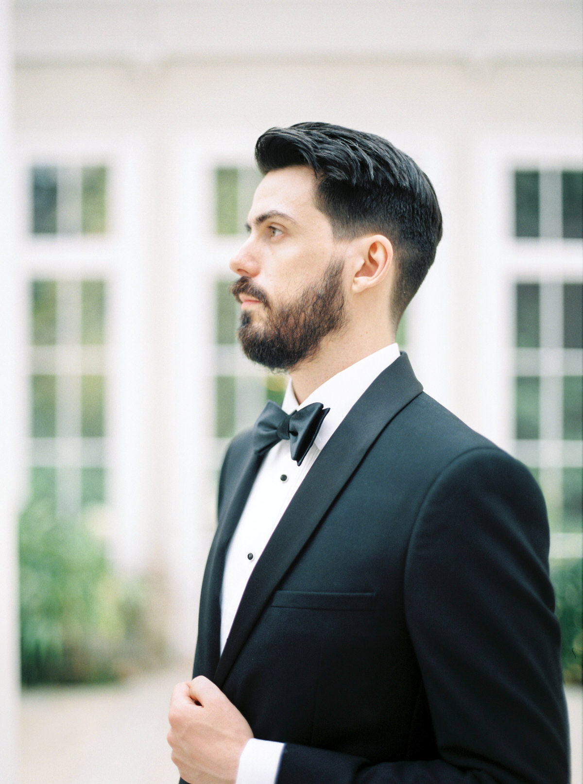 Handsome groom in tuxedo black tie wedding